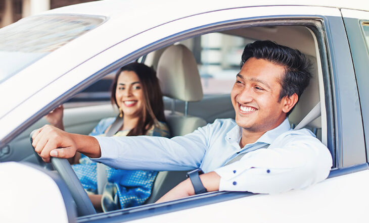 Male driving car with a woman in the passenger seat