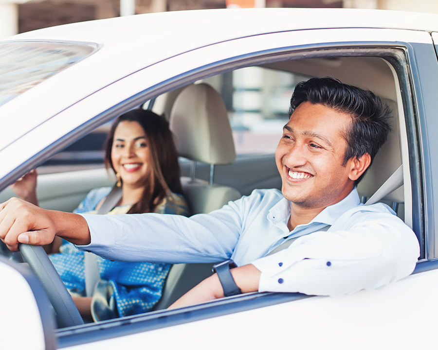 Male driving car with a woman in the passenger seat