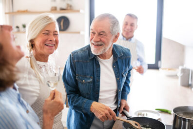 Mature family and friends cooking together