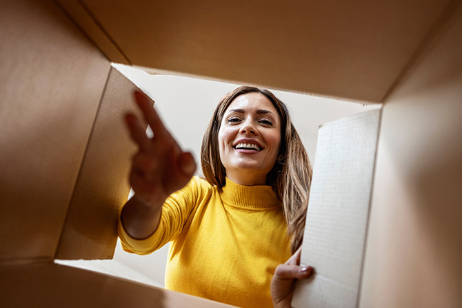 Woman looking inside a moving box