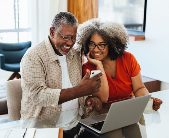seniors on couch with cell phone