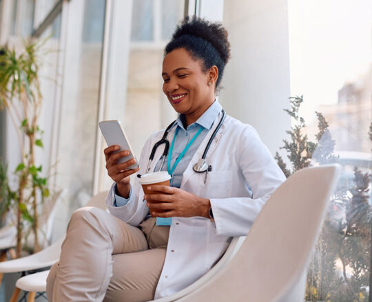 doctor in white lab coat on cell phone
