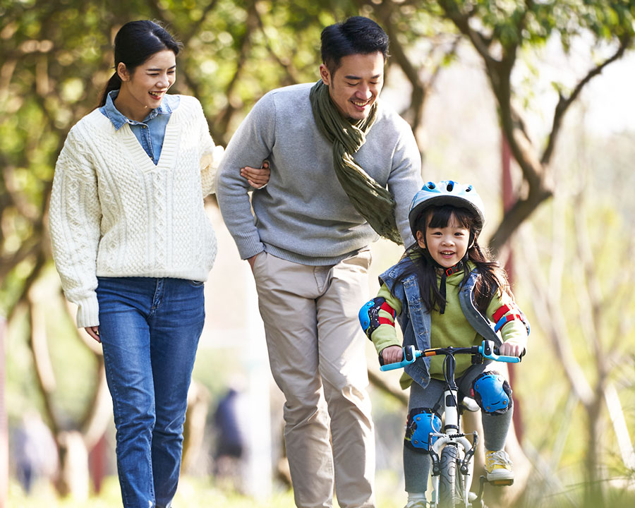 family with girl on bike