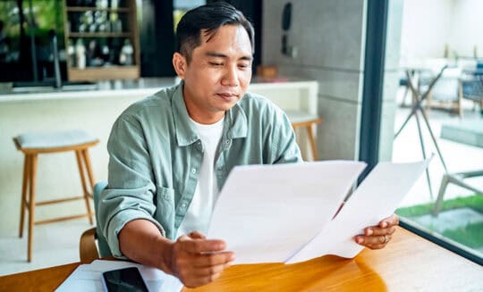 man reviewing auto insurance policy