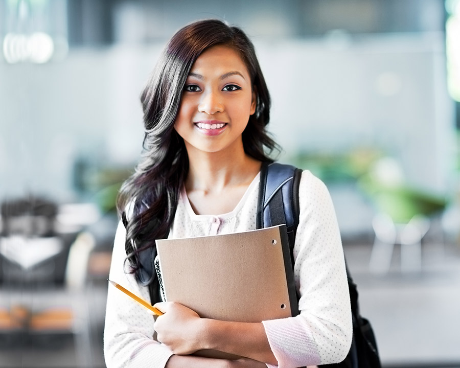 student holding books