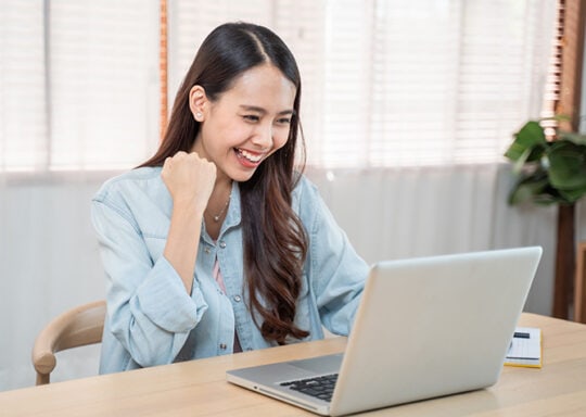 happy woman at laptop